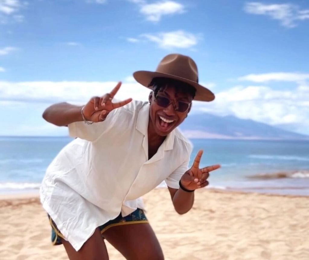 woman standing on beach in hawaii giving peace signs