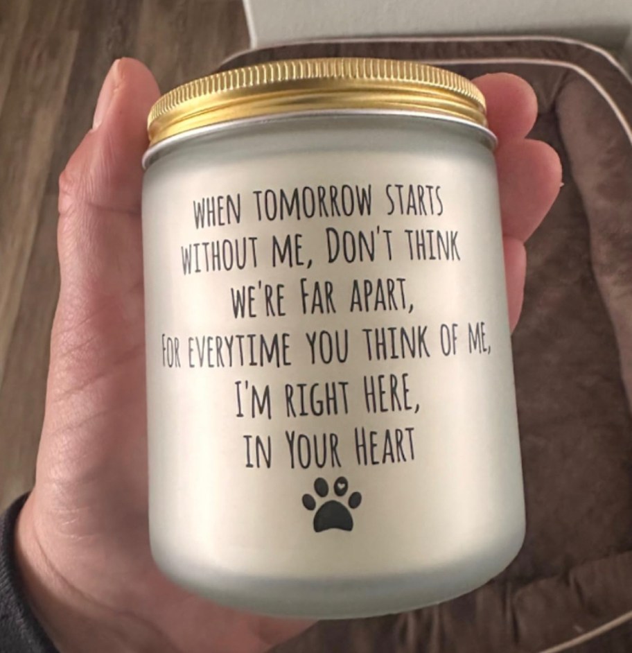 hand holding dog memorial sympathy candle