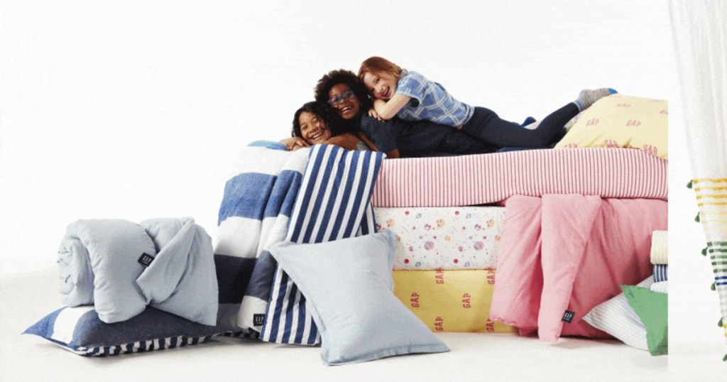 kids on piles of colorful bedding