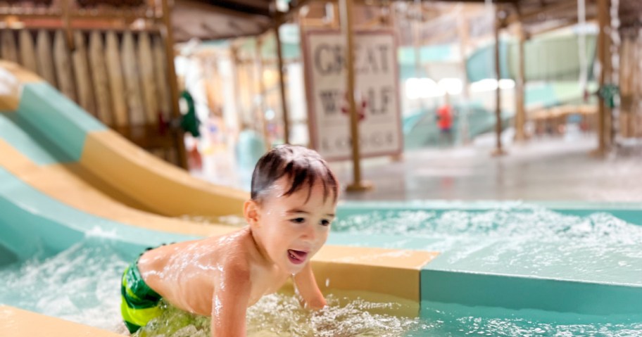 Boy at the end of a slide at the waterpark