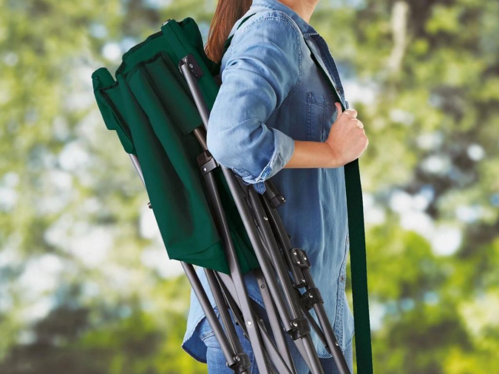 woman carrying green Member's Mark Oversized Double Hard Arm Chair