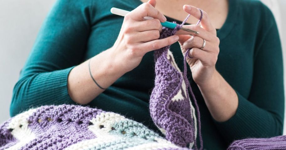 woman knitting an afghan