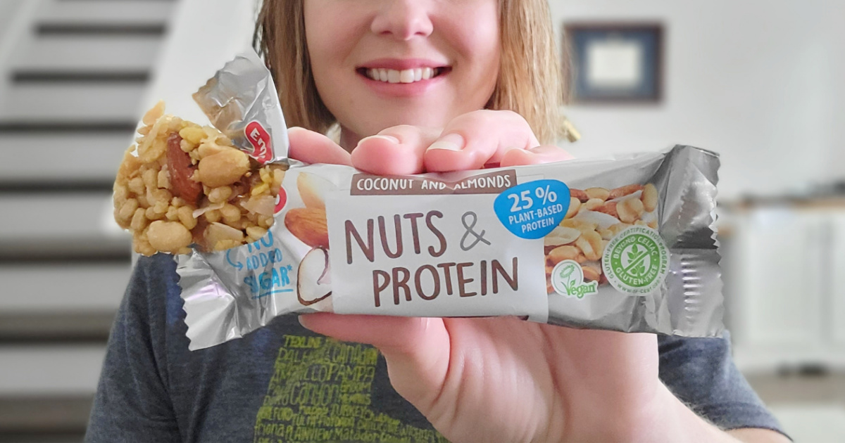 woman holding a protein nut bar