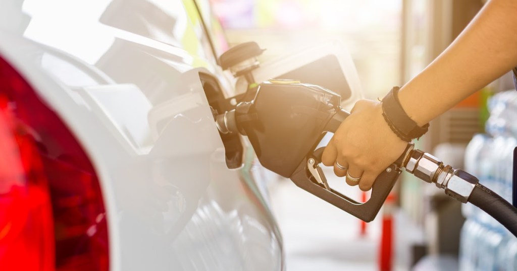 person pumping gas at gas station