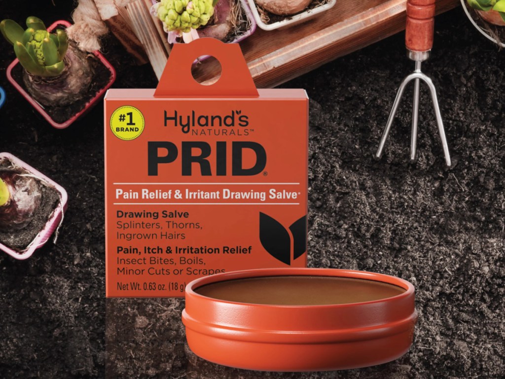 Hylands Prid balm in dirt by garden tools