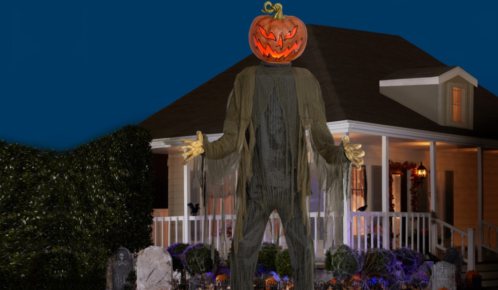 huge pumpkin ghoul decor in yard at night