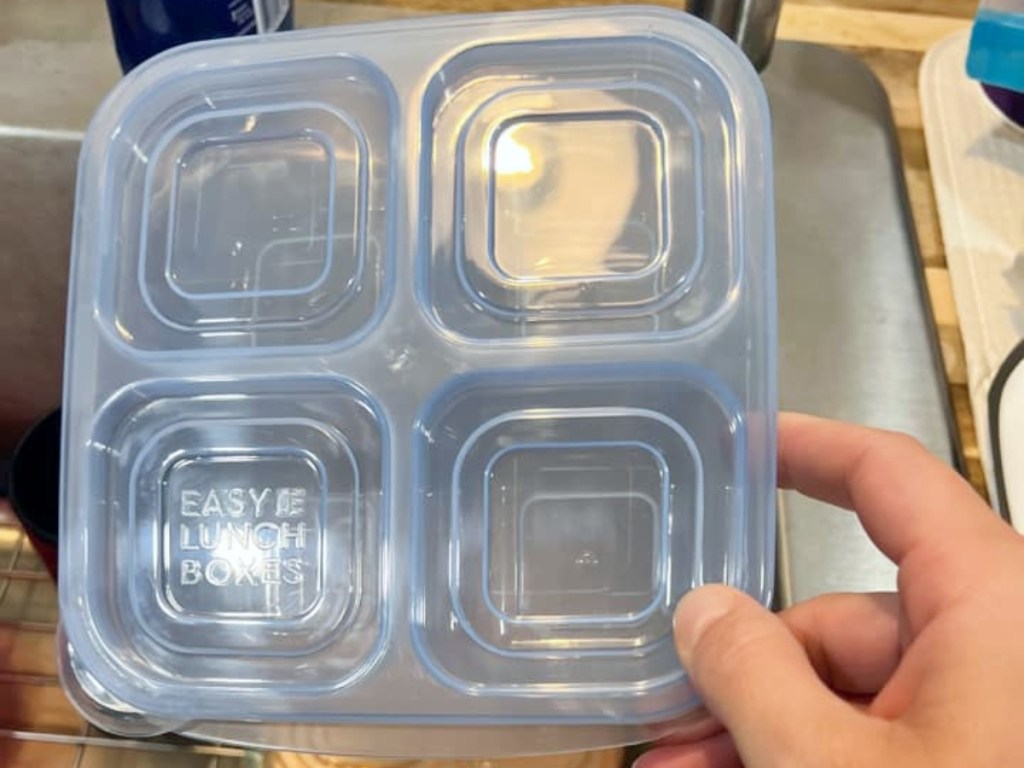 holding a blue bento box