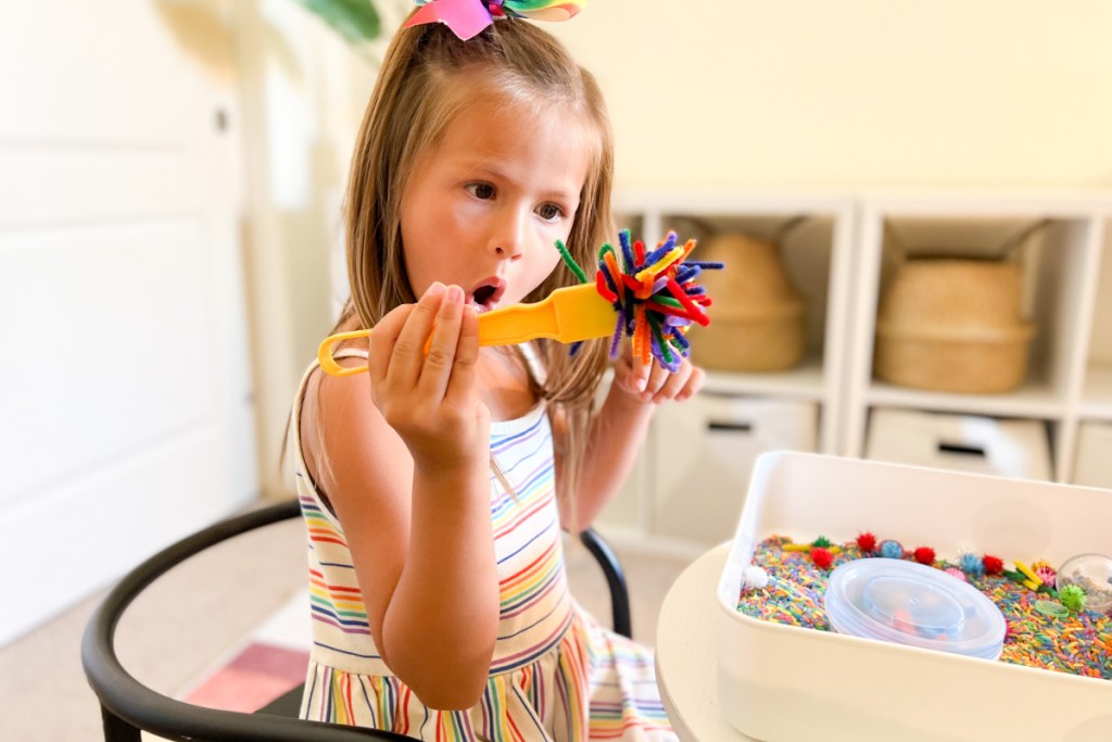 girl with mama of joy sensory bin