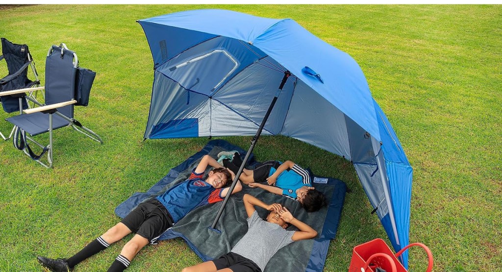 kids at soccer playing in HUGE XL umbrella