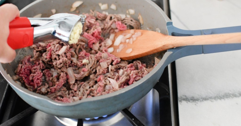 making ground beef with onions in a skillet