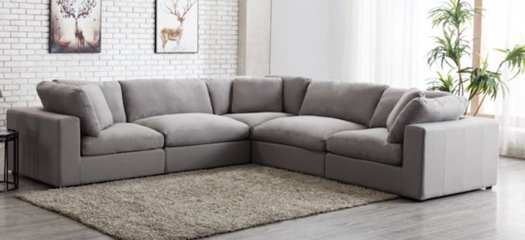 dark gray modular sectional sitting in stock living room