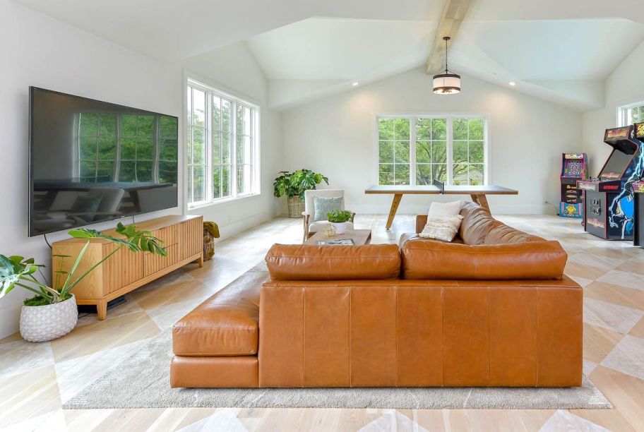 leather camel colored sectional in game room