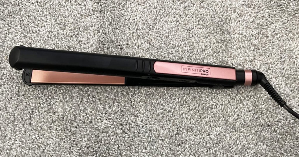 black and rose gold Conair Flat Iron on carpet