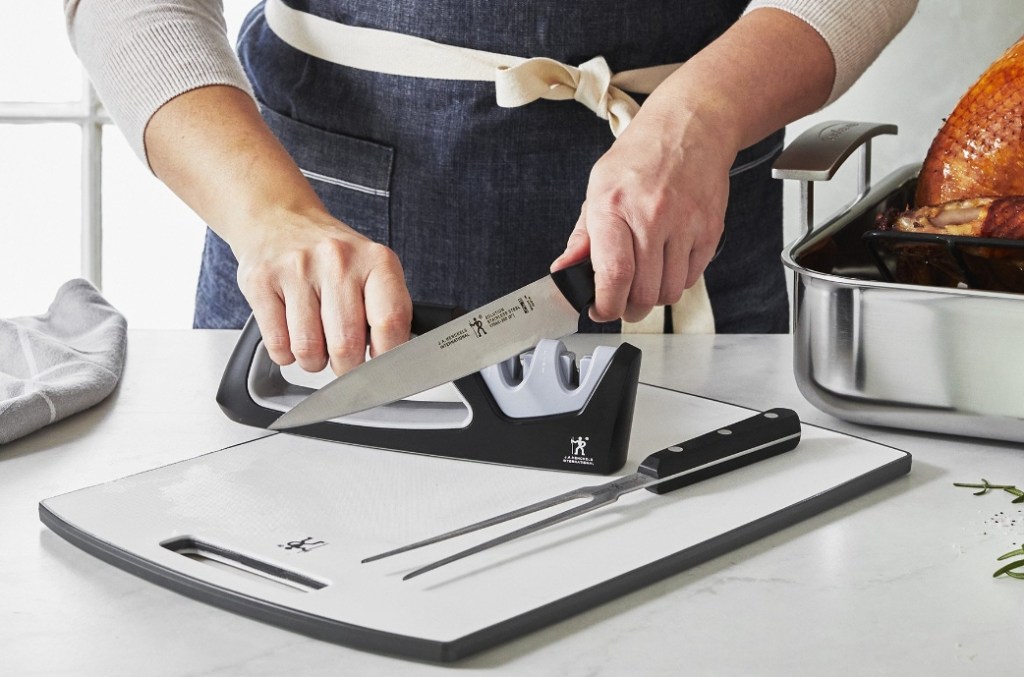 person sharpening a knife