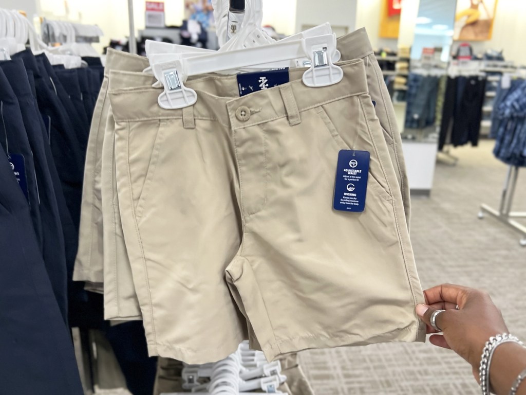 hand touching pair of uniform shorts