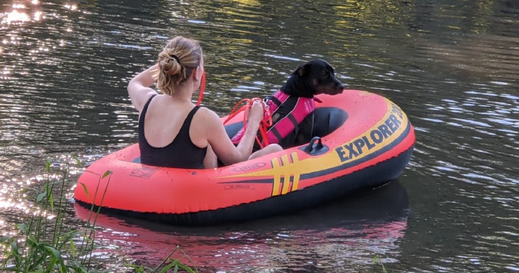 woman and dog in intex boat