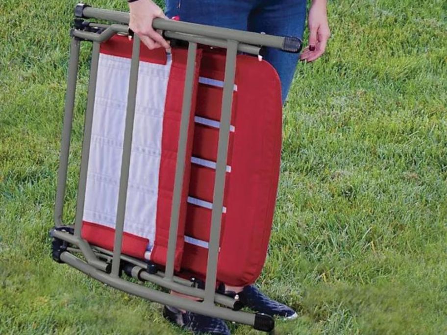 Person holding a folded Member's Mark folding rocking chair