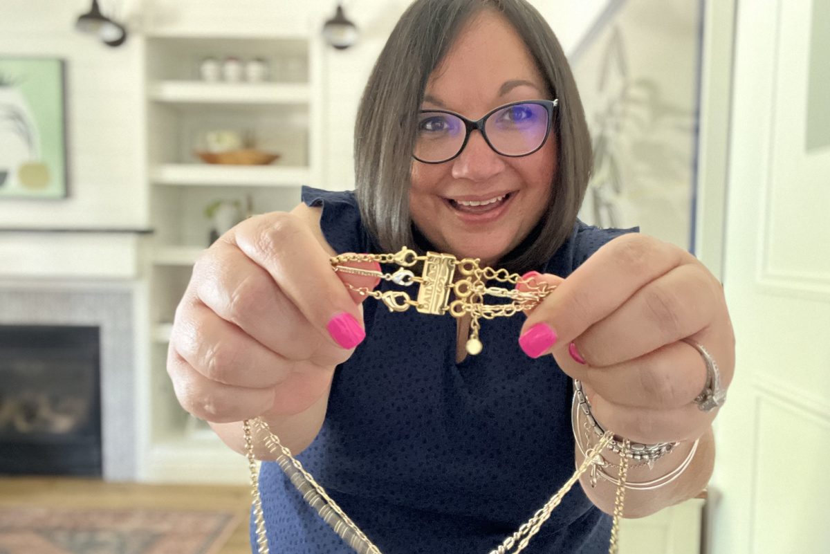 a woman holding a magnet clasp for a necklace