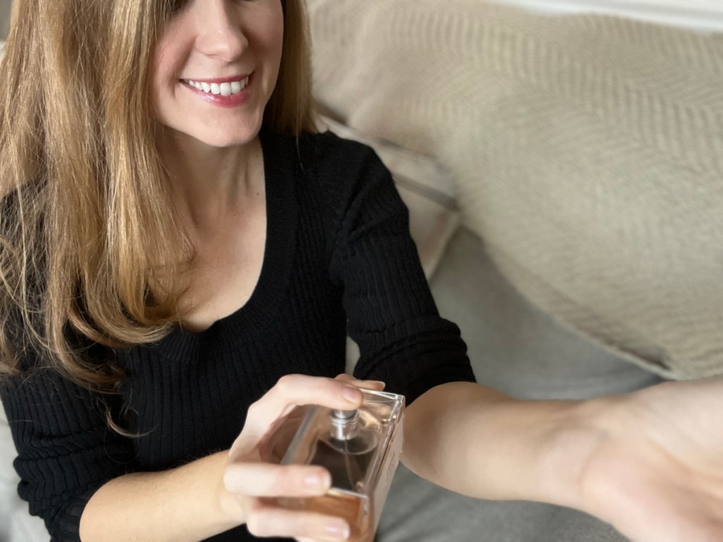 woman spraying gourmand perfume