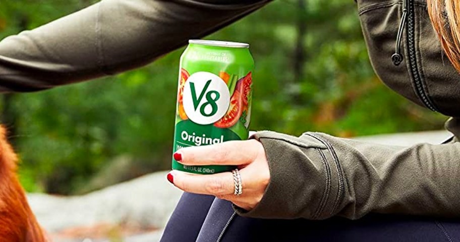 V8 Can being held by a woman outdoors