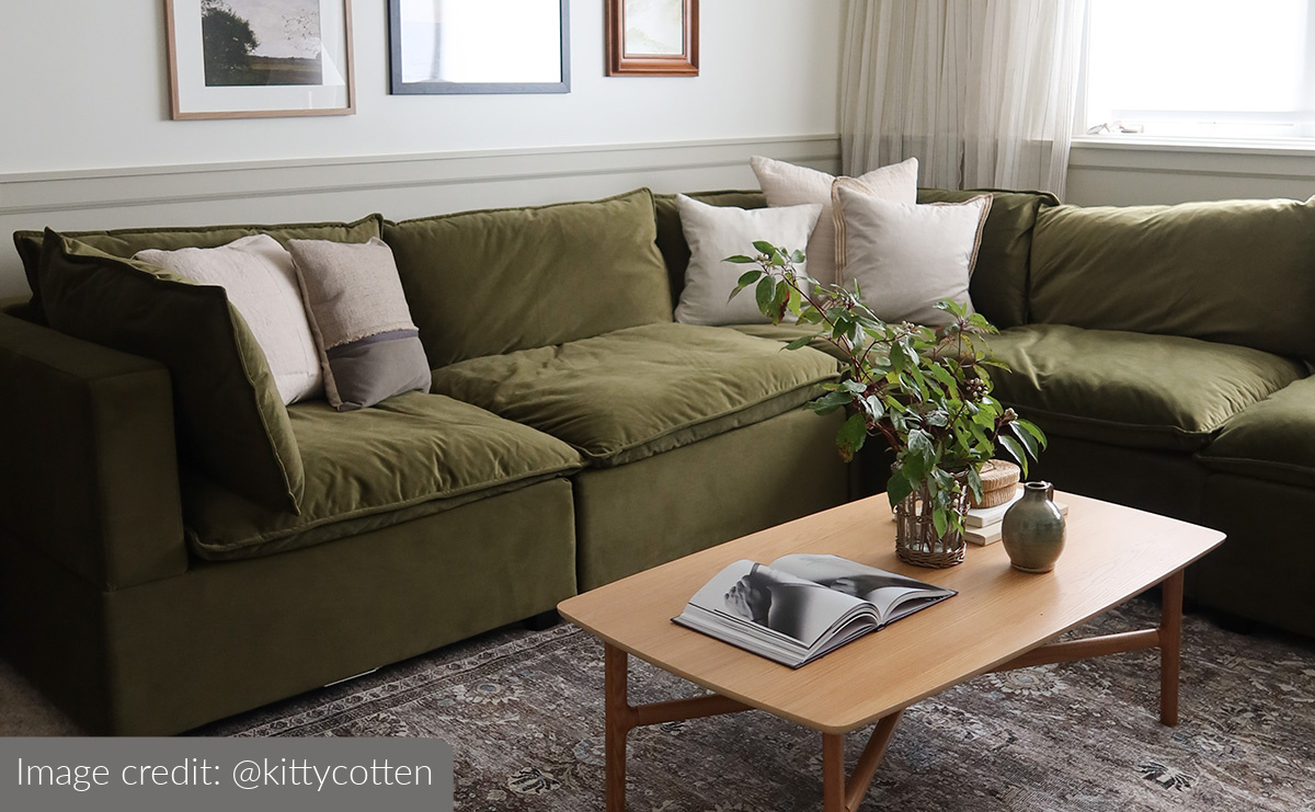 dark green football sectional in living room