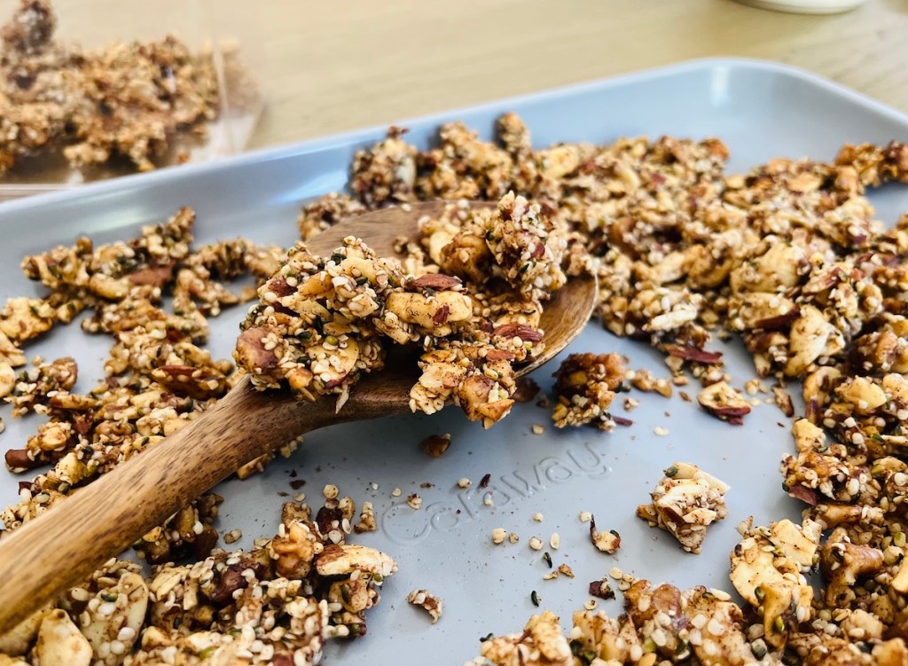 close up of caraway logo on sheet pan with cooked granola on top