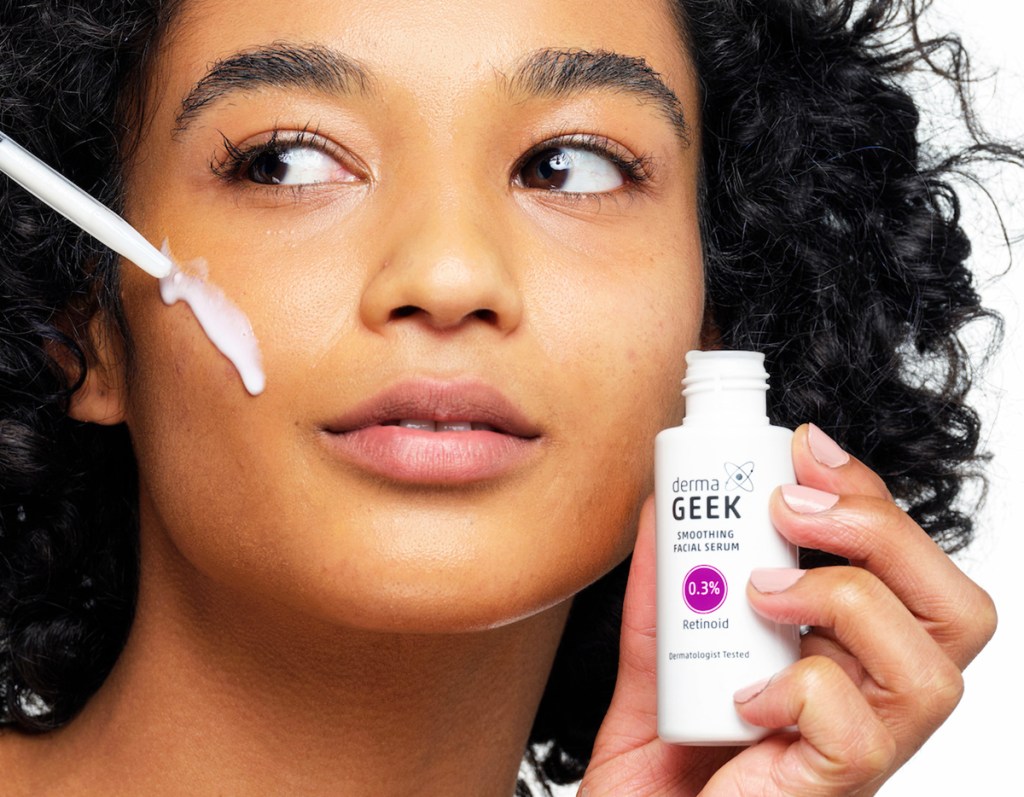 woman applying dermaGEEK Facial Serum to face