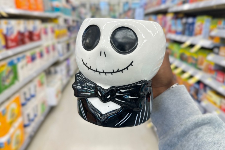 hand holding nightmare before christmas mug inside of the store