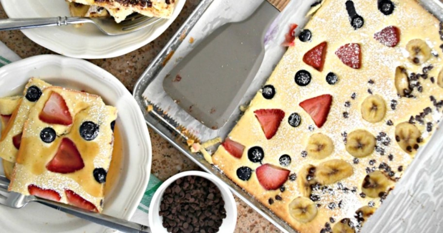 sheet pan with pancakes on top with strawberries and blueberries