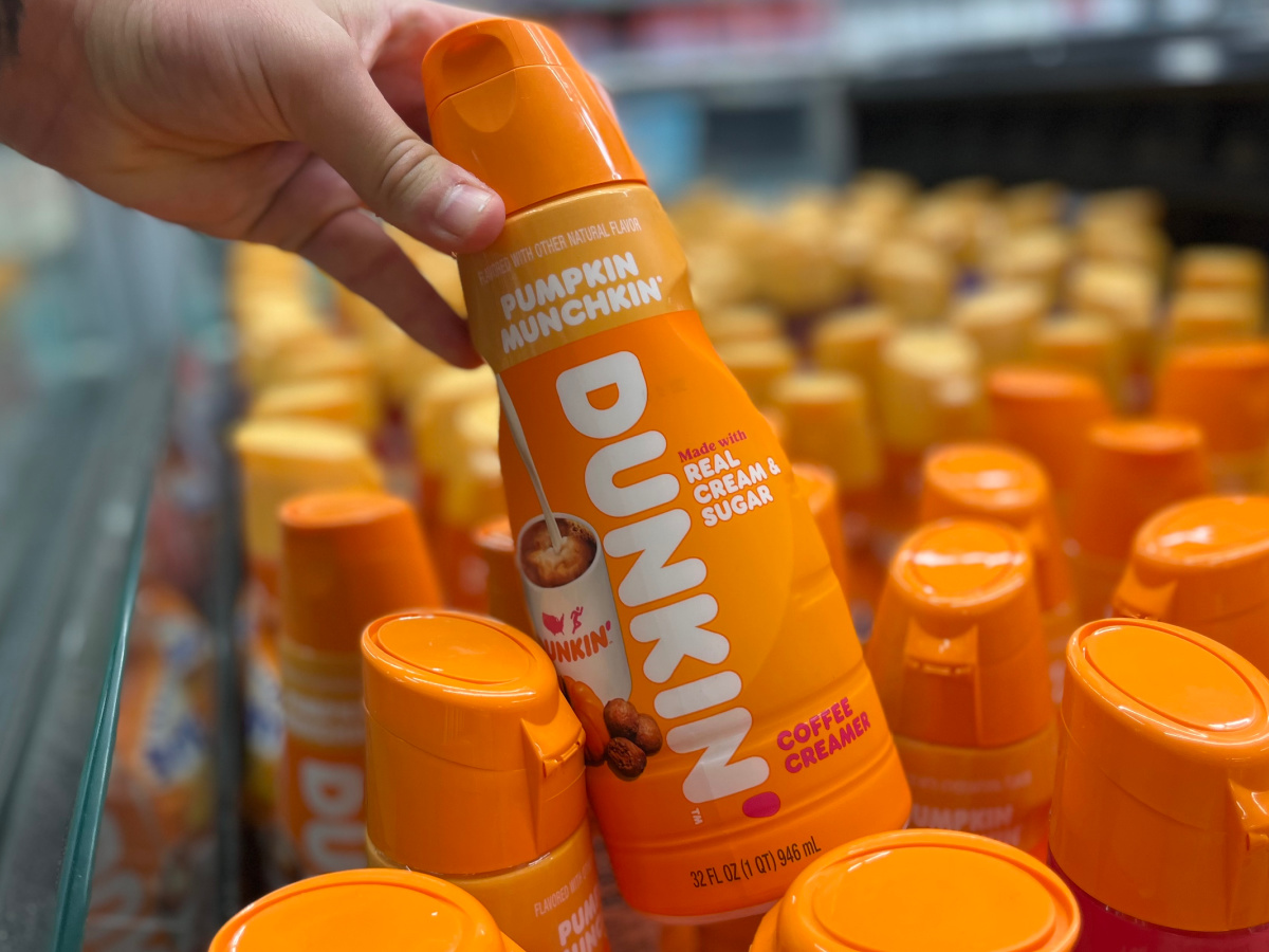 hand reaching for a bottle of dunkin pumpkin munchkin creamer