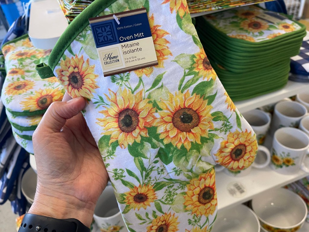 hand holding sunflower oven mitt