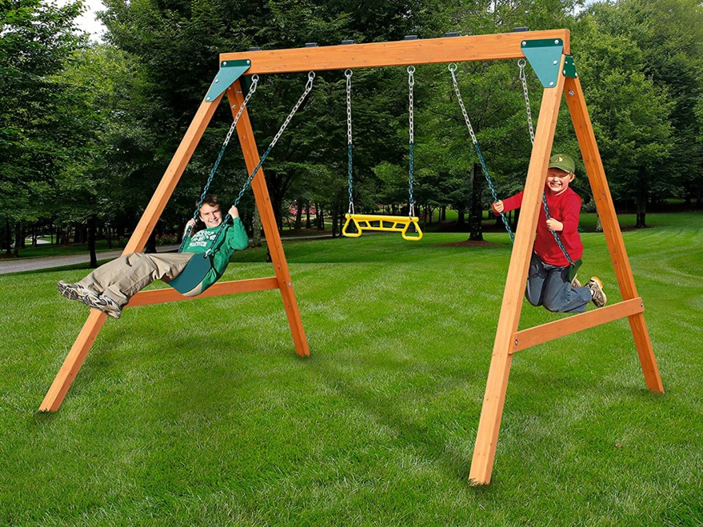 two boys playing on swing set