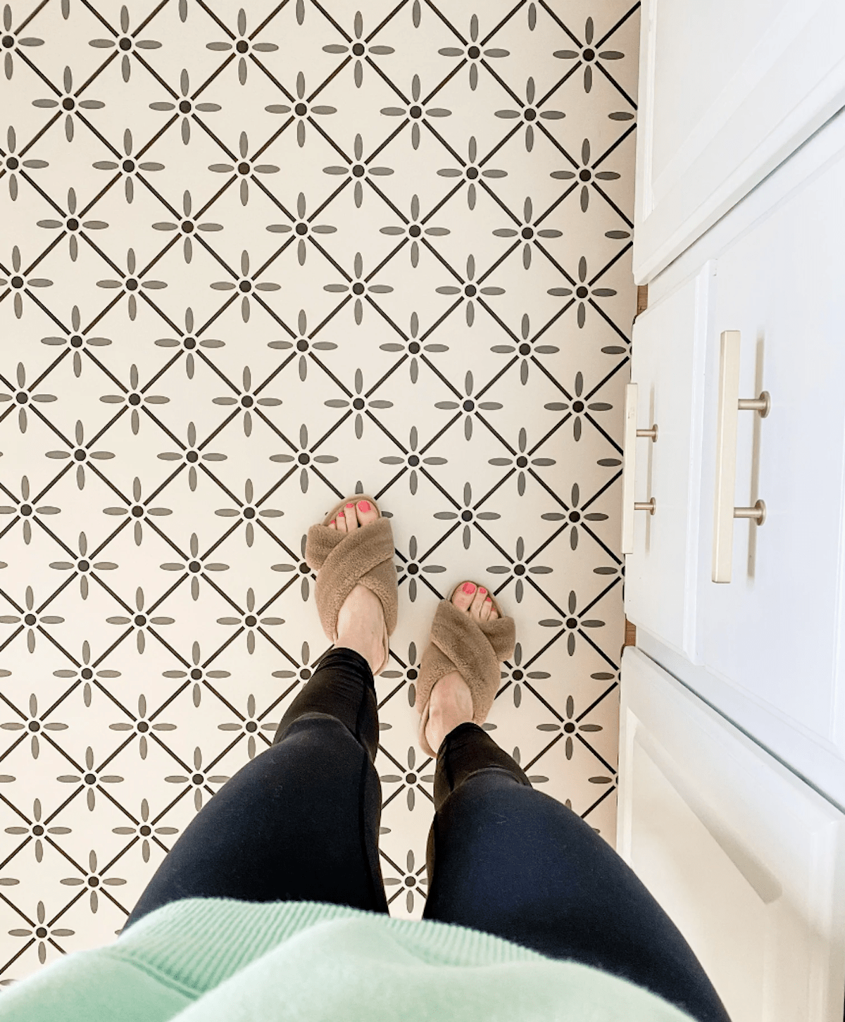 patterned floor with white cabinets