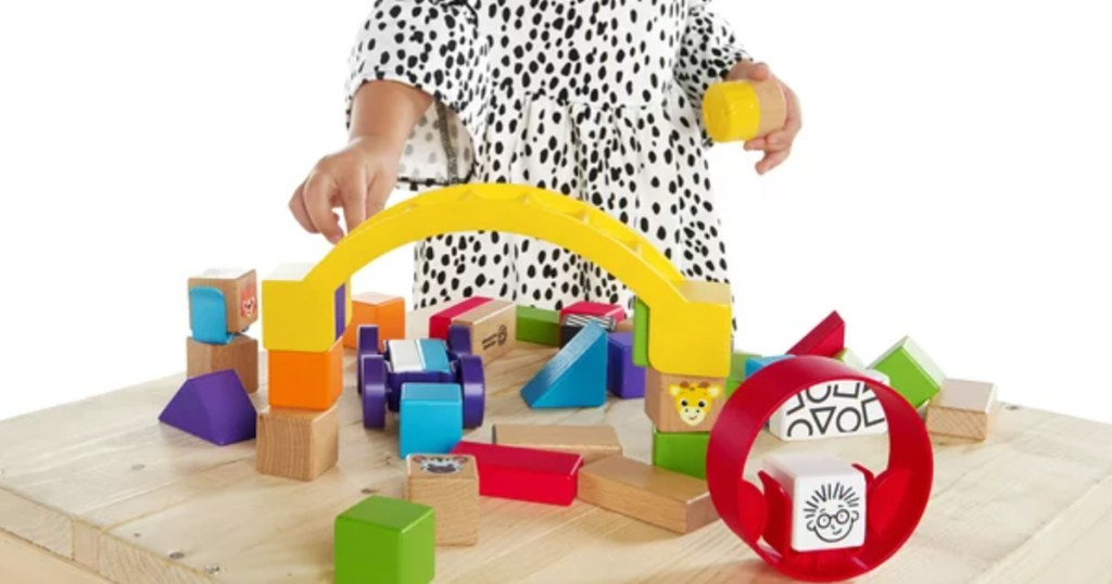 kid playing with wooden block set