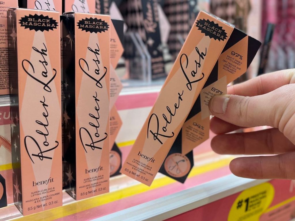 Hand grabbing a benefit roller lash mascara from the shelf at Ulta