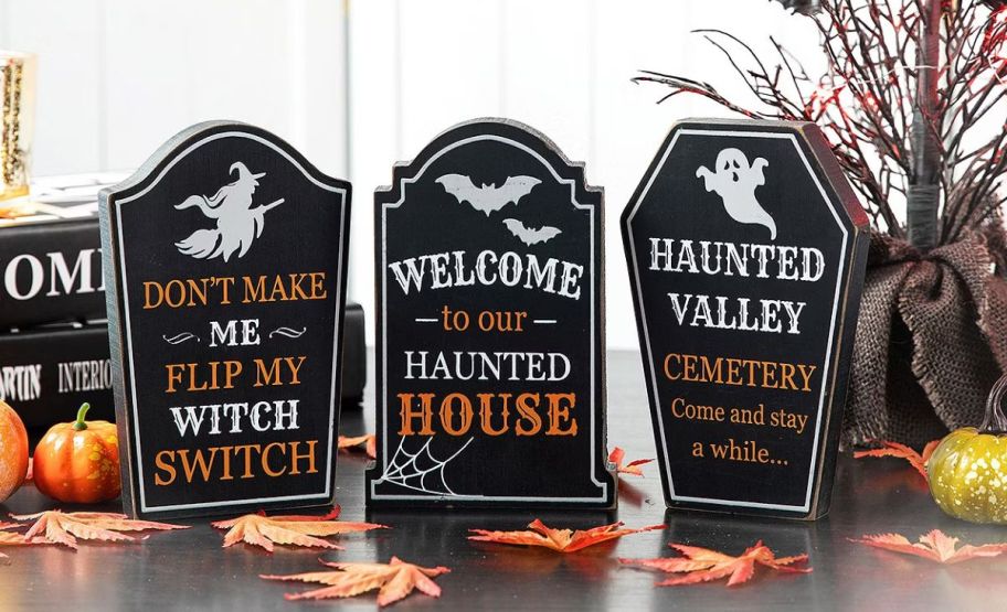 a set of 3 tombstone shaped tabletop decor pieces on a table top