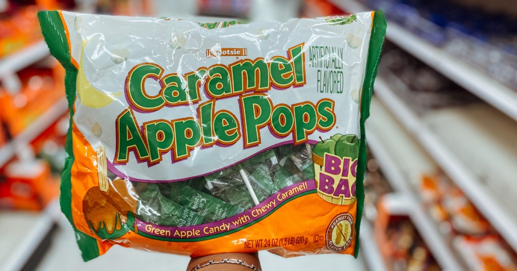 Hand holding carmel apple pops