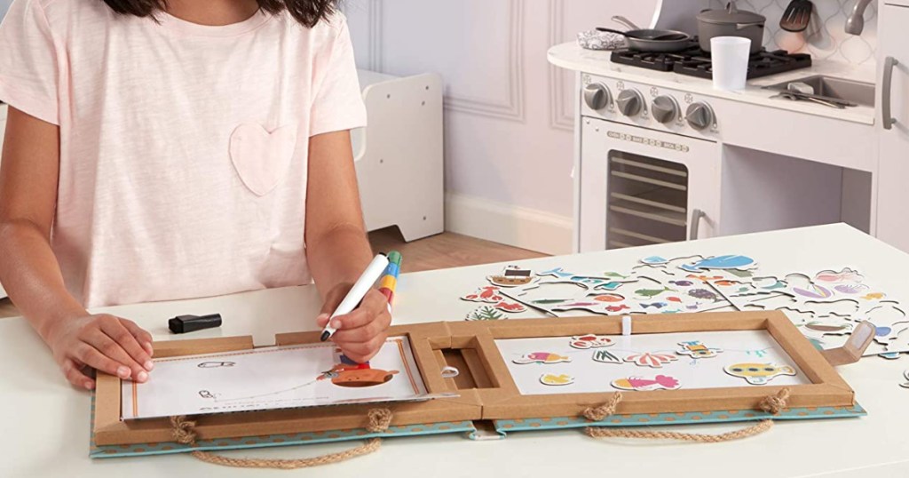 Kid using Melissa and Doug activity kit