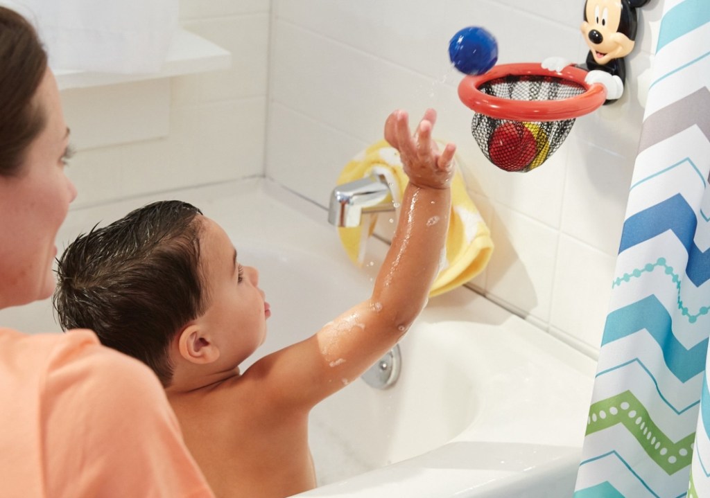 boy playing with a Mickey Mouse Shoot and Score Toy