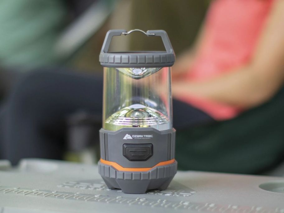 Ozark Trail 200 Lumen LED Battery Powered Lantern on table outside