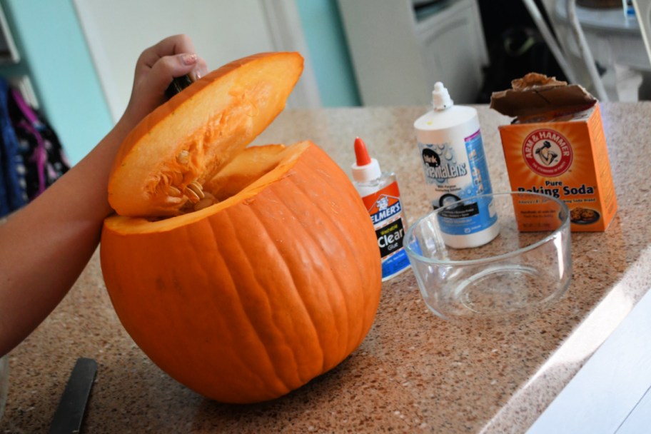 Carving the top of a pumpkin