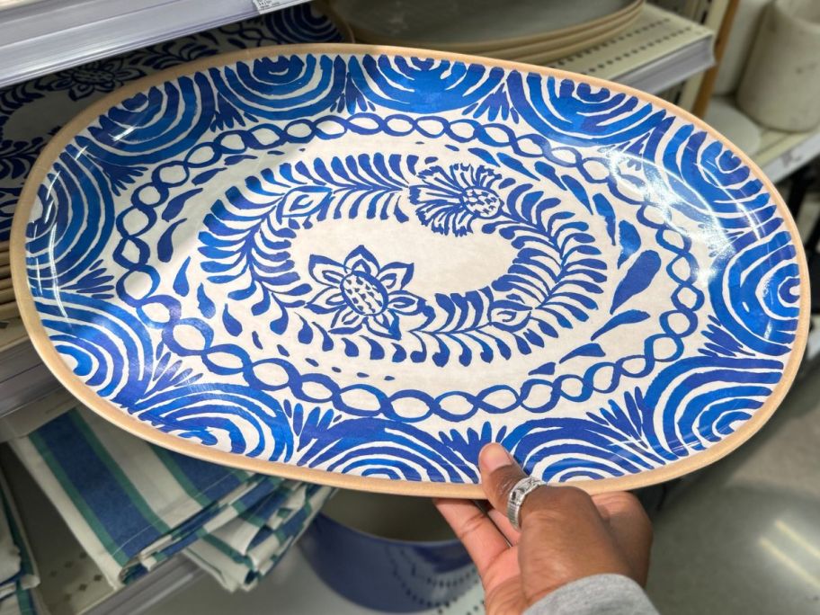 Hand holding a Threshold Melamine Oval Serving Platter 