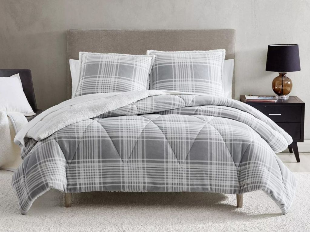 gray and white plaid onlineforter on bed