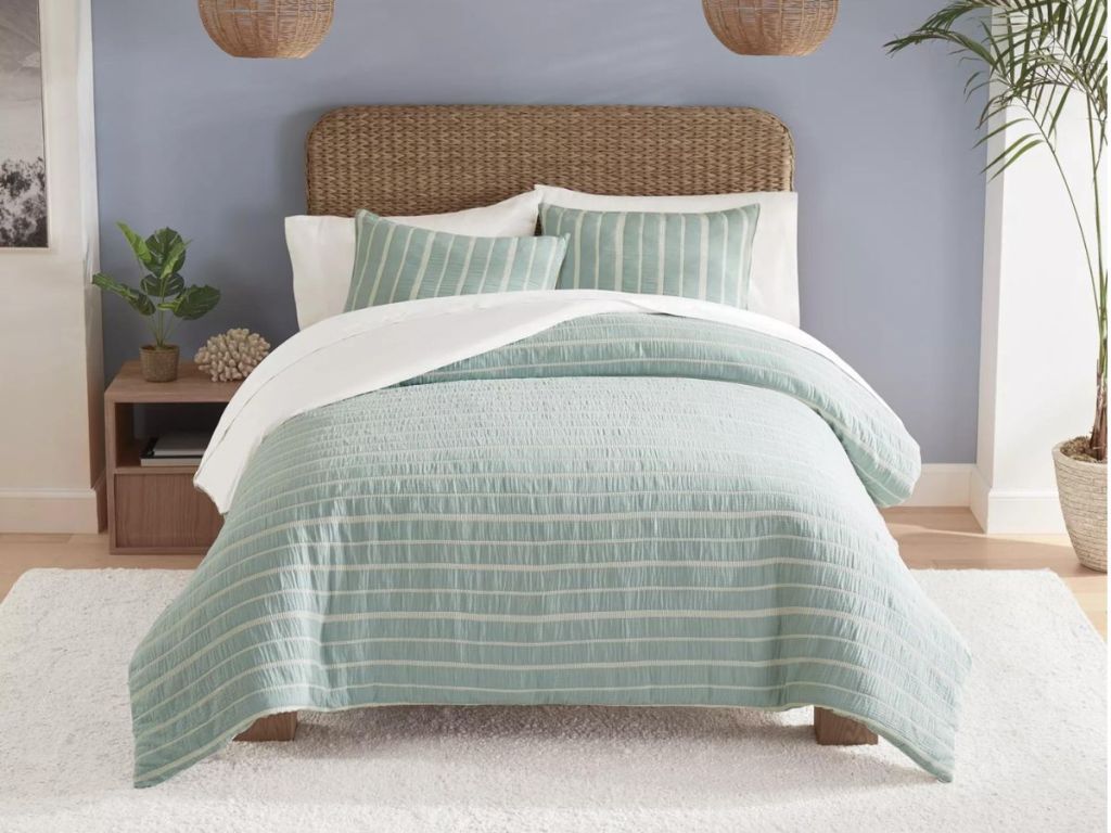 white and mint green striped onlineforter on bed