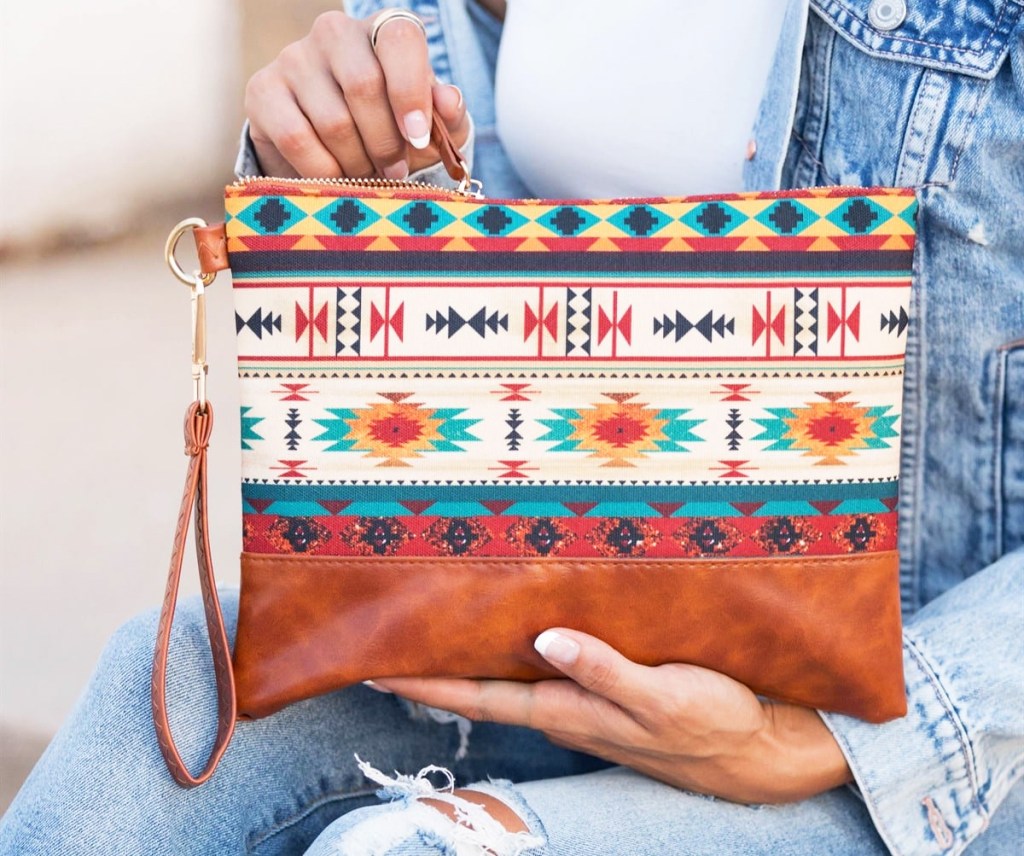 woman holding large printed clutch