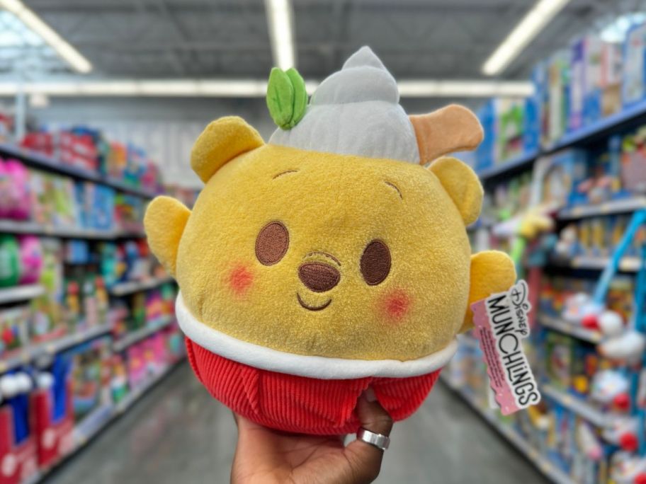 Disney Munchling Plush - Winnie-The-Pooh in hand in store