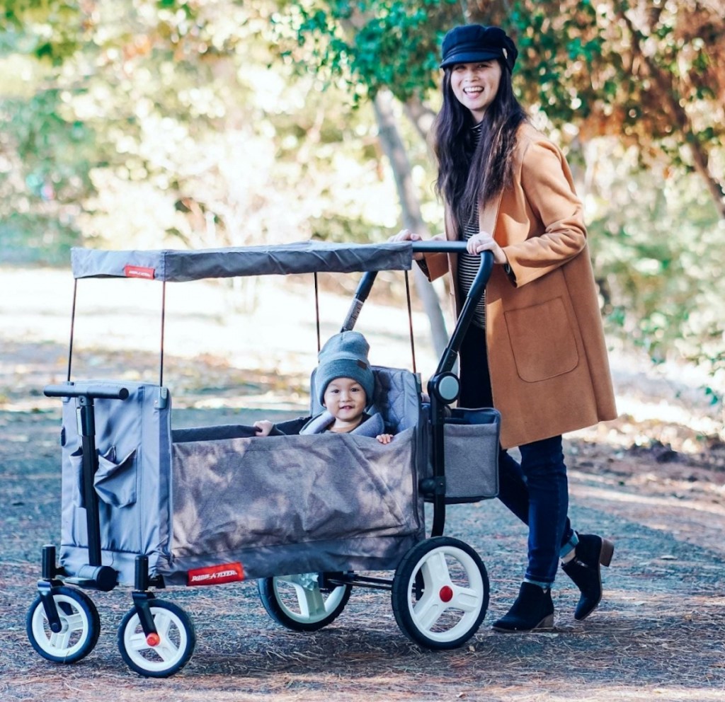 woman pushing wagon in park