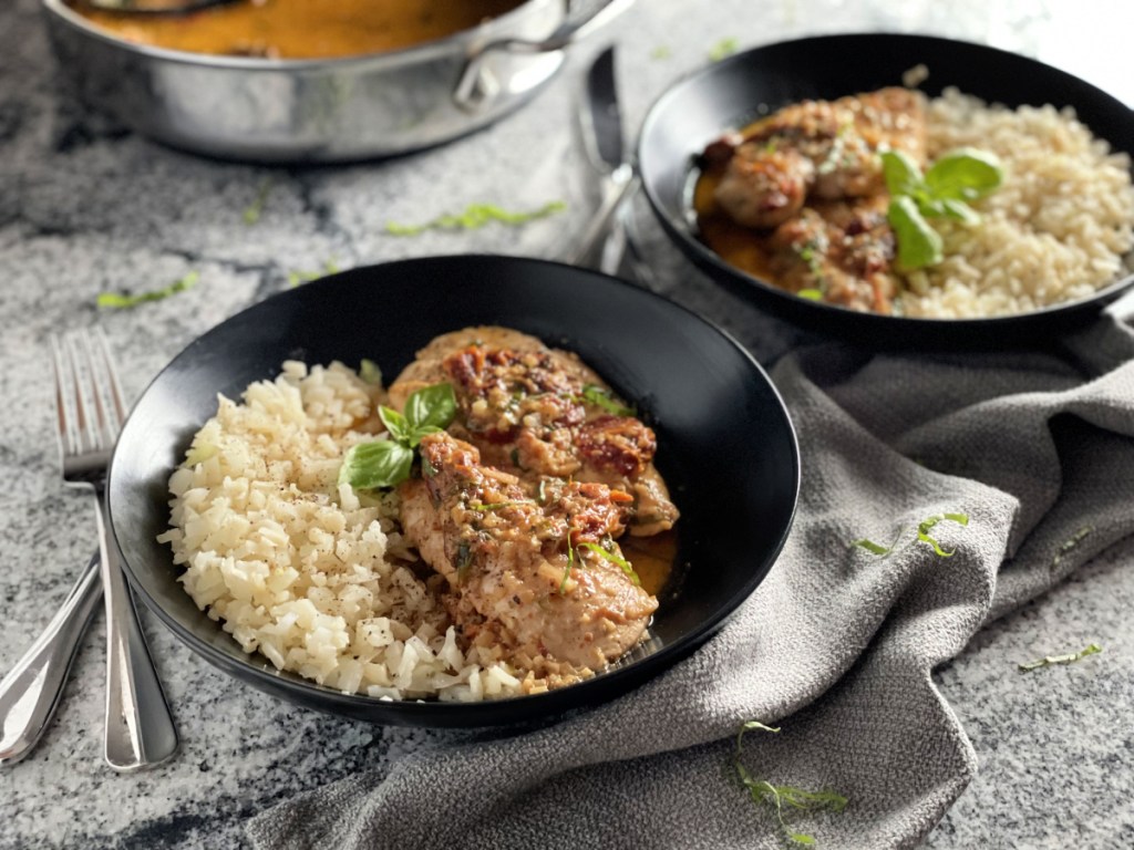 sun-dried tomato chickien plated with a side of cauliflower rice