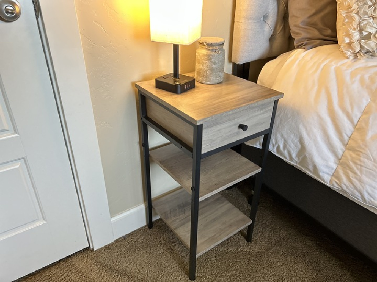 a wooden Wayfair nightstand displayed in a bedroom