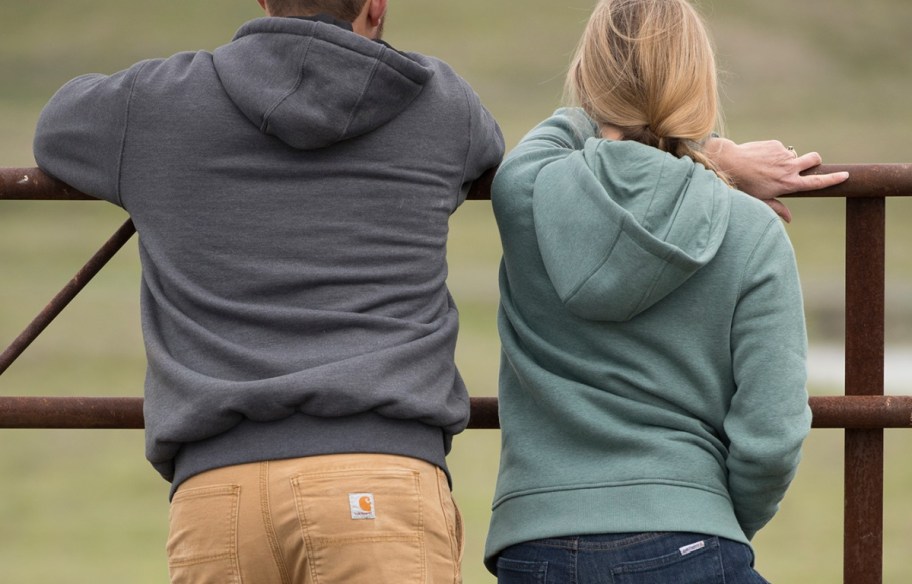 woman and man wearing Carhartt sweatshirts